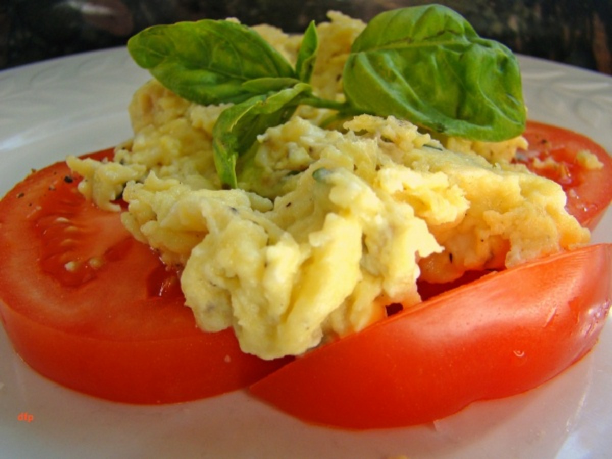 Scrambled Eggs Over Fresh Sliced Tomatoes And Basil