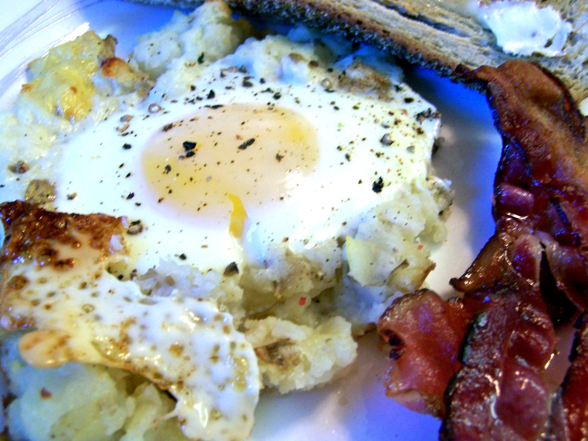 Baked Eggs On A Bed Of Potatoes With Bacon
